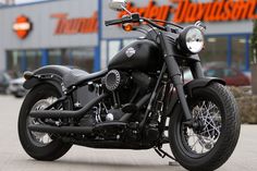 a black motorcycle parked in front of a store