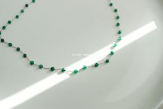 Emerald Green Color Glass 2mm Gem Beaded Necklace. Spaced beaded necklace with gold clasp, perfect by itself or to layer. Aesthetically pleasing to wear anywhere from the beach to work. length ---14 inches in length with a 2 inch extender details ---Finish Chain is Gold color ---Color and Pattern is pretty much same as sample photo but handmade means shades and color placement can be different! ---Lobster Clasp care ---Treat delicately to extend its life ---Chain/Pendants are gold dipped so plea Minimalist Green Beaded Chain Jewelry, Green Minimalist Beaded Chain Jewelry, Emerald Green Color, Jewelry Chain, Bestie Gifts, Gold Dipped, Glass Bead Necklace, Jewelry Pouch, Aesthetically Pleasing