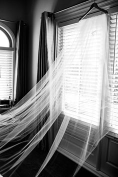 a bed with sheer curtains hanging from it's side