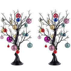 two christmas trees with ornaments hanging from them