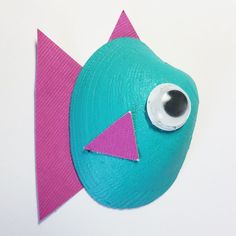 a close up of a paper plate with a fish on it's face and eyes