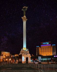 the night sky is filled with stars and lights, as well as an obelisk