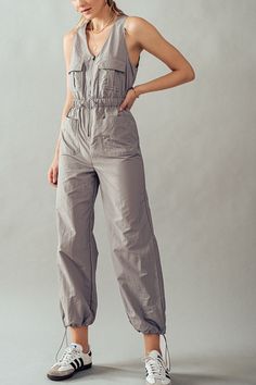 "Step into effortless chic with our V-Neck Zip-Up Midi Jumpsuit. This sleeveless tactical jumpsuit is crafted from 100% nylon, offering durability and style in one sleek package. Featuring a practical cargo design and an elastic waistband for comfort, this jumpsuit is perfect for festivals, summer adventures, vacations, cruises, and resort getaways. Available in a range of vibrant color options, it's the epitome of fashionable utility. Small (2/4), Medium (6/8), Large (10) *Measurements were taken laying flat Inseam for all size is 31-31.5\" Model is Wearing Size Small. Model: 5'9\"  32C bust, 25\" waist, and 36\" hips.  Color may vary slightly due to monitor resolution  100% Nylon NO REFUNDS-please check sizing Perfect, Soft Cozy top to wear with your Dainty Accessories. Active or lounge, Utility Style Sleeveless Jumpsuits And Rompers With Pockets, Fitted Sleeveless Khaki Jumpsuits And Rompers, Sleeveless Khaki Jumpsuit With Pockets, Summer Utility Sleeveless Vest, Utility Sleeveless Vest For Summer, Sleeveless Khaki Jumpsuits And Rompers For Spring, Fitted Utility Vest Sleeveless, Summer Sleeveless Utility Vest, Fitted Sleeveless Utility Vest