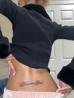 a woman with a tattoo on her lower back