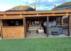 a backyard bar with outdoor furniture and lights on the roof, next to a fenced in area