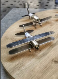 a wooden cutting board topped with knives and knives on top of it's sides