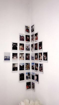 a cross made out of photos is hanging on the wall in front of a white wall