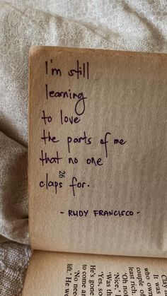 an old book with writing on it and a handwritten quote from ruby francisco about learning to love the parts of me that no one claps for