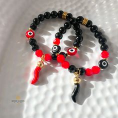 Elevate Your Style with Our Handmade Cornicello and Evil Eye Beaded Bracelet - Choose Your Protection in Red or Black!  Our Handmade Cornicello and Evil Eye Beaded Bracelet is a unique piece of jewelry meticulously crafted for those who seek not just fashion but also the protective energies of the Cornicello and Evil Eye. Dual Protection Options: Select your preferred Cornicello charm - opt for the bold and vibrant red or the sleek and mysterious black. Each choice adds a layer of protection, ma Red Spiritual Bracelet With Black Beads, Red Bohemian Bracelet With Black Beads, Black Beads Stretch Bracelet As Gift, Red Stretch Bracelet With Black Beads As A Gift, Bohemian Black Charm Bracelet As Gift, Handmade Black Charm Bracelet For Party, Bohemian Black Charm Bracelet Gift, Handmade Black Bangle Charm Bracelet, Handmade Black Bohemian Charm Bracelet