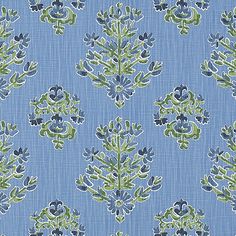 a blue and green floral pattern on fabric