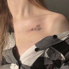 a woman with a small tattoo on her chest