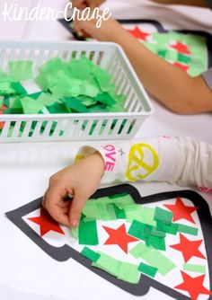 two children are making christmas cards with green and red paper