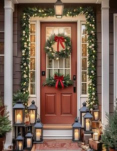 a christmas wreath on the front door of a house with lit candles and wreaths