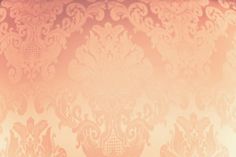 an orange and pink wallpaper with ornate designs on it's side, as well as a clock