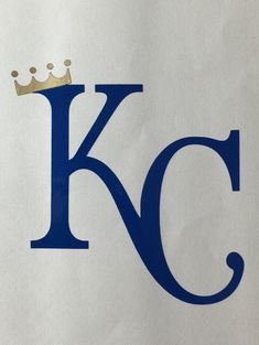 the letter k has a crown on it's head and is blue with white lettering