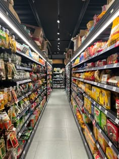 an aisle in a grocery store filled with lots of food