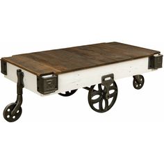 an old wooden table with wheels on it