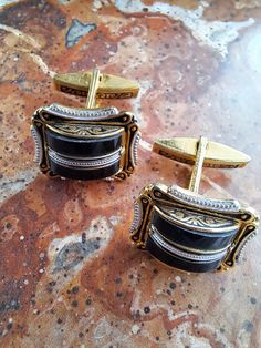 This is a very striking pair of gold tone g damascene cufflinks.They are Spanish and were made in the 1960s era.They are made of gold tone metal and faux glass ebony.The cufflinks are rectangular in shape 2cm x 1 5cm in size.There is lovley detail in the decoration.The cufflinks are in very good condition with just a little wear and tear.The swivel mechanism works well on both..Please study the pictures and check the sizes.They come with a velvet drawstring bag. We opened our art/vintage jewelry Vintage Engraved Jewelry For Business, Engraved Retro Jewelry For Formal Occasions, Antique Engraved Cufflinks For Formal Occasions, Formal Engraved Cufflinks, Antique Engraved Cufflinks For Formal Wear, Vintage Gold Cufflinks For Wedding, V Boyfriend, Antique Silver Cufflinks For Formal Occasions, Antique Engraved Cufflinks For Anniversary