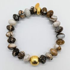 Made with a stunning combination of Wood Jasper and 24 karat Gold-plated Brass, this bracelet exudes elegance and sophistication. The organic patterns of the Wood Jasper add a touch of natural beauty, while the 24 karat Gold-plated Brass adds a luxurious touch. Ro & Gieo Wood Jasper and 24 karat Gold-plated Brass Bracelet Bead size - 10 - 11.5 mm Bracelet length - 7 inches If you want your bracelets in a different size than 7 inches, we are more than happy to accommodate your request. Please sim Gold Bracelets With Round Beads And Oyster Bracelet, Adjustable Gold Stretch Bracelet With Gemstone, Elegant Gold Beaded Bracelets With Natural Stones, Handmade Gold Nature-inspired Bracelets, Gold Bracelets With Natural Round Beads, Gold Stretch Bracelet With Gemstones As Gift, Luxury Gold Bracelets With Gemstone Beads, Gold Bracelets With Round Natural Stones, Luxury Gold Beaded Bracelets With Gemstones