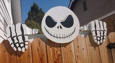 a wooden fence with a skeleton painted on it