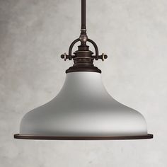 an old - fashioned light fixture hangs from the ceiling in front of a white wall