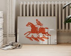 an image of a horse and rider on the wall next to a radiator