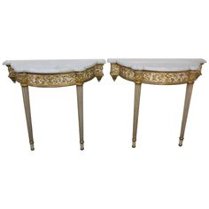 pair of gilded console tables with white marble top and gold leaf decoration, circa 1950's