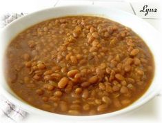 a white bowl filled with beans on top of a table