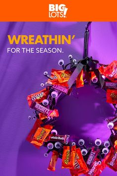 a wreath made out of candy bars on a purple background