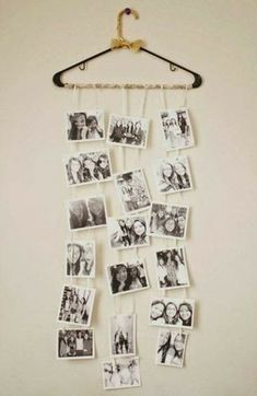 a bunch of pictures hanging on a wall with clothes pins attached to it and some hangers