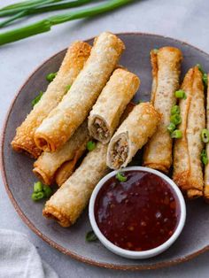 fried spring rolls on a plate with dipping sauce