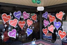 a store front with many hearts on the window