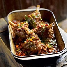 a metal pan filled with meat and vegetables