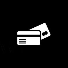 a black and white photo with a credit card in front of it, against a dark background