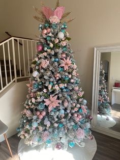 a decorated christmas tree with pink and blue ornaments