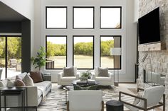 Embrace the beauty of natural light with this stunning wall of windows by Andersen Windows in Hunter’s Cove living room!  These expansive windows not only flood the space with sunlight but also offer breathtaking panoramic views of the 140-acre estate. The sleek, black frames create a striking contrast with the warm stone fireplace. #AndersenWindows #LivingRoomDesign #NaturalLight #ArtisanHomeTour #HuntersCove #ModernRustic #CustomHome #InteriorDesign #HomeInspiration Modern Rustic Home, Andersen Windows, Modern Rustic Homes, Hunter S, Black Frames, Living Room Windows, House Decorating, House Windows