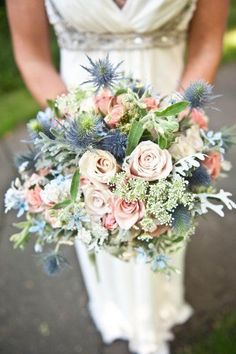 a woman holding a bouquet of flowers in front of a pink and blue color palette