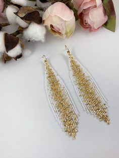 "White and gold romantic beaded earrings, galaxy seed bead earrings, wedding beaded jewelry Length 5\" including ear wire Width 1\" Made with best quality Japanese seed beads, and 24k gold dipped seed beads Lightweight and unique extravagant style - designed and made by Luba Ro Colors used - white, shimmering gold and gold Select closure earwires leverbacks clip-ons for non pierced ears" Gold Earrings With Spacer And Round Beads, Gold Earrings With Beads For Celebration, Elegant Gold Beaded Earrings With Spacer Beads, Gold Tiny Beads Drop Earrings, Gold Drop Earrings With Tiny Beads, Gold Earrings With Tiny Beads For Gifts, Gold Earrings With Faceted Round Beads, Gold Beaded Earrings With Faceted Round Beads, Gold Chandelier Earrings With Gold Beads