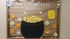 a bulletin board with some writing on it and a pot of gold coins in the middle