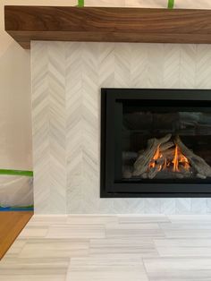 Fireplace Tiles Herringbone, Fireplace Tile And Mantle, Black Herringbone Tile Fireplace Surround, Neutral Tile For Fireplace, Fireplace Design With Tv Above, Minimalist Tile Fireplace, Mosaic Tile On Fireplace, White Chevron Fireplace, Chevron Electric Fireplace Wall