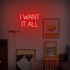 a red neon sign that says i want it all above a room with pictures on the wall