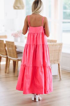 This designer dupe maxi dress is amazing. We love the tiered detailing and criss cross strappy neckline. Fit: Oversized and flowy, model is wearing size small Sundress With Adjustable Straps And Tiered Shape, Flowy Pink Tiered Dress For Vacation, Spring Layered Maxi Dress, Layered Maxi Dress For Spring, Flowy Tiered Dress For Casual Occasions, Vacation Tiered Dress With Adjustable Straps, Adjustable Straps Tiered Dress For Vacation, Tiered Dress With Adjustable Straps For Vacation, Pink Tiered Maxi Dress For Vacation