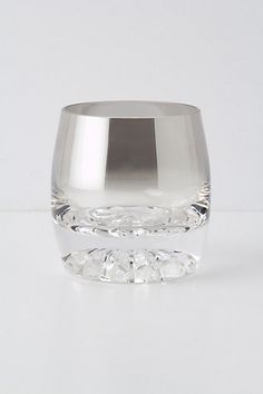 an empty glass on a white surface