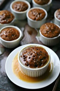 chocolate muffins with caramel sauce on a plate next to other muffins