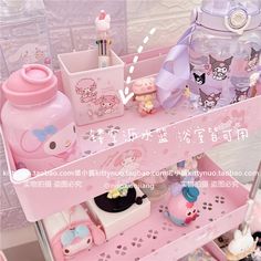 a pink shelf with various items on it and an animal themed container in the middle