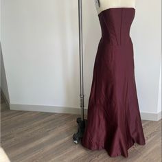 Merlot Evening Gown With Boning And Corset Back Size 8 But Fits More Like A Size 6 Fitted A-line Maxi Dress With Sweep Train, Fitted Full Length Satin Gown, Silk Fitted Bridesmaid Gown, Fitted Strapless Bridesmaid Gown, Full Length Fitted Gown With Lined Bodice, Fitted Floor-length Bridesmaid Gown, Fitted Full-length Gown With Lined Bodice, Fitted Lined Maxi Dress For Prom, Strapless Fitted Lined Maxi Dress