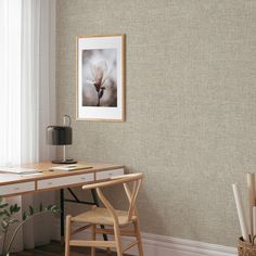 a desk and chair in a room with a painting hanging on the wall above it