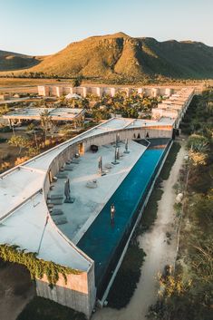 an aerial view of a swimming pool surrounded by mountains