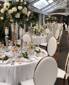 the tables are set with white and gold decorations