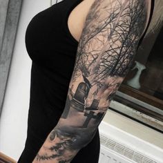 a woman with a black and white tattoo on her arm